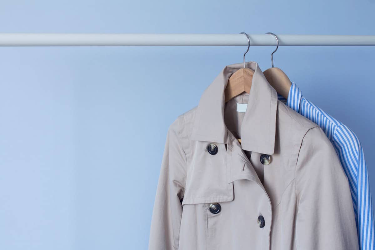 A trench coat hanged on the cabinet