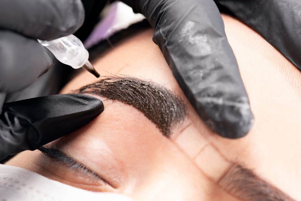 A woman getting her eyebrows microblade, 13 Types Of Microblading