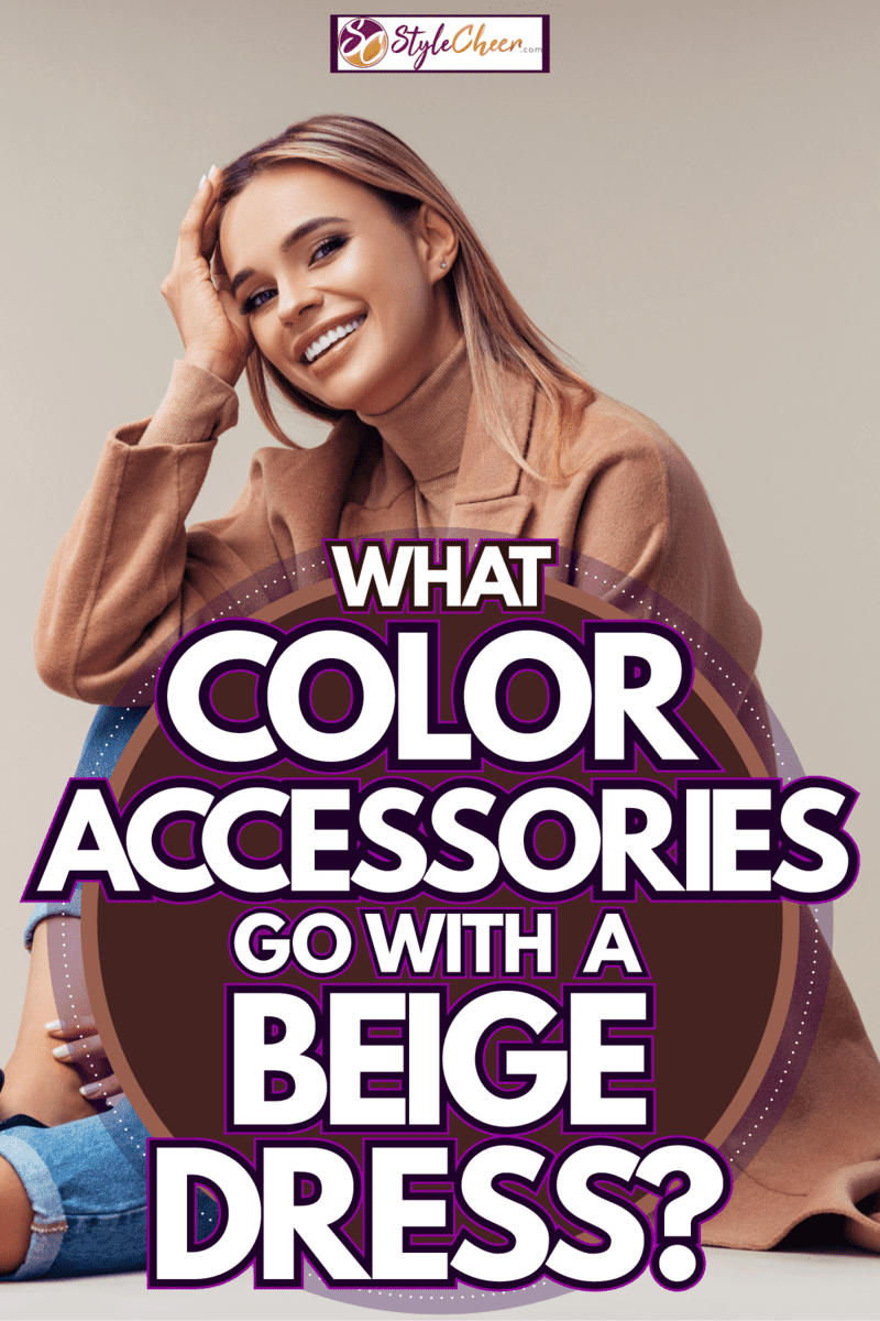 A smiling blonde woman wearing denim jeans and a beige jacket, What Color Accessories Go With A Beige Dress?