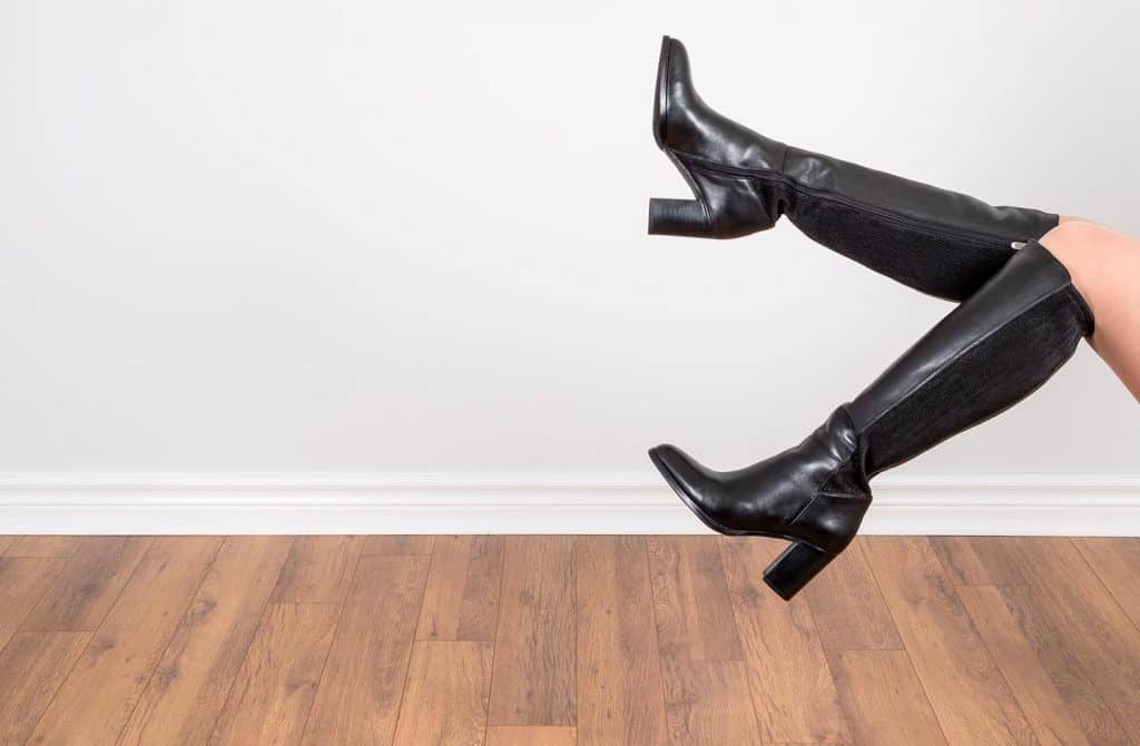 Woman modelling black knee high leather boots
