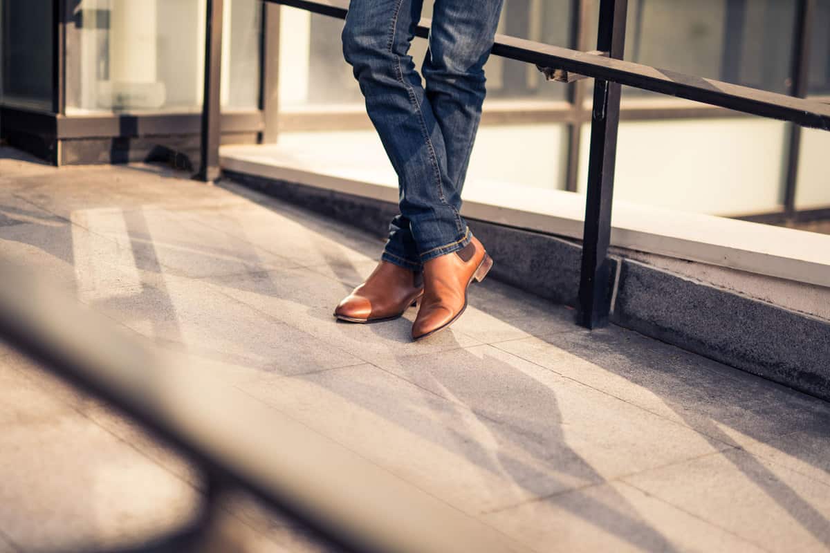 Man wearing jeans and leather shoes