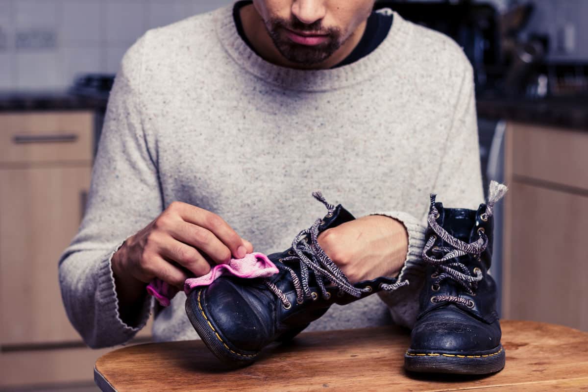 Man cleaning and taking care of his leather shoes