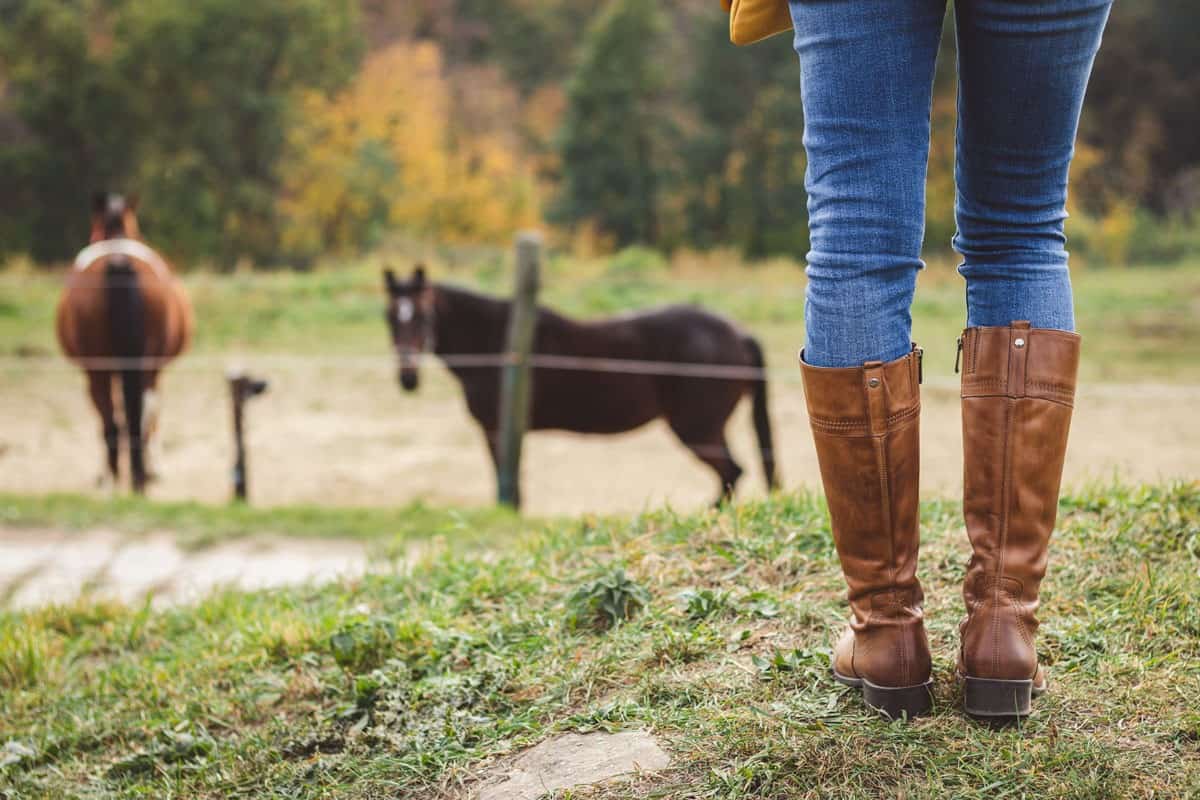 Woman wearing leather boots while at the ranch