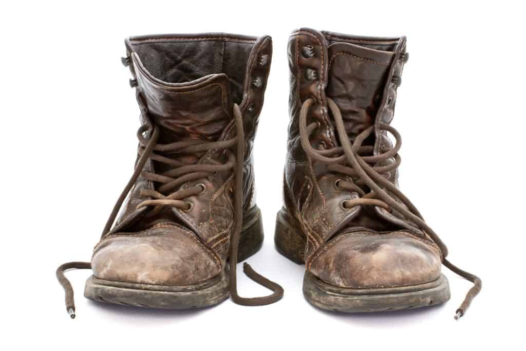 Dirty old boots isolated over white background

