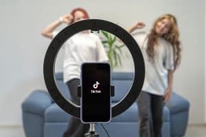 Two teenage girls are filming a video for their Tiktok vlog at their home, Tiktok Is Killing Personal Style - What You Can Learn From The Devil Wears Prada