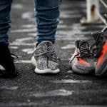 A person wearing a Yeezy 350 V2 "Oreo", a Yeezy 350 "Turtle Dove" with a pair of Yeezy 350 V2 "Beluga" on the side, [The Scoop] Viral Sensation Discovers Low-Cost Yeezy Dupe at Walmart