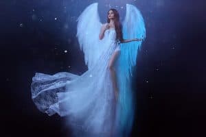 Fantasy woman angel soars in the air with white huge bird wings, Micarah Tewers' Angel Barbie Wings Tutorial Goes Viral: Get the Look on a Budget