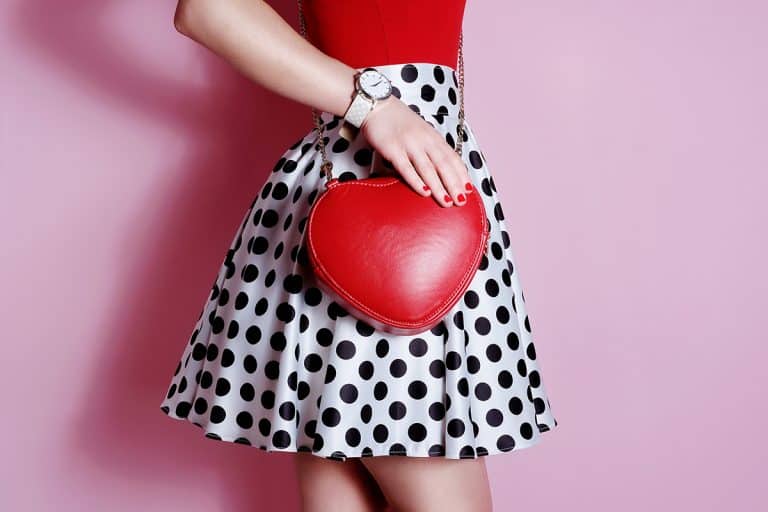 Fashion small heart shape red bag in hand of girl, The Power of Love: Heart Shaped Purses Prove Fashion is More Than Just Trends
