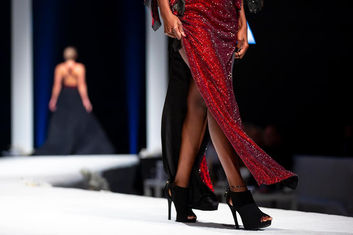 Female models walk the runway in beautiful red dress during a fashion show