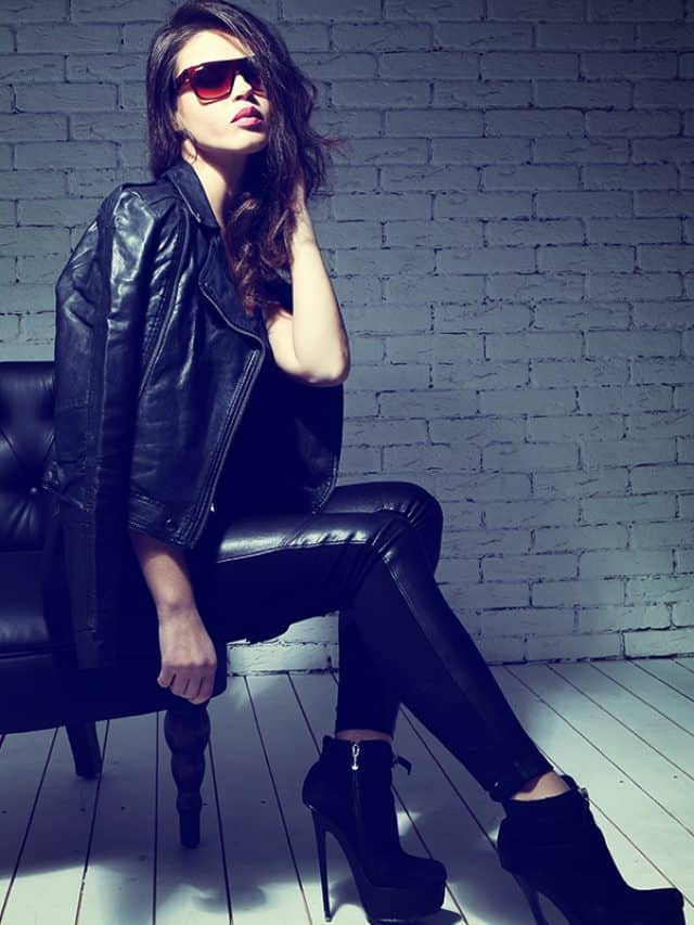 Fashion model in sunglasses, black leather jacket, leather pants
