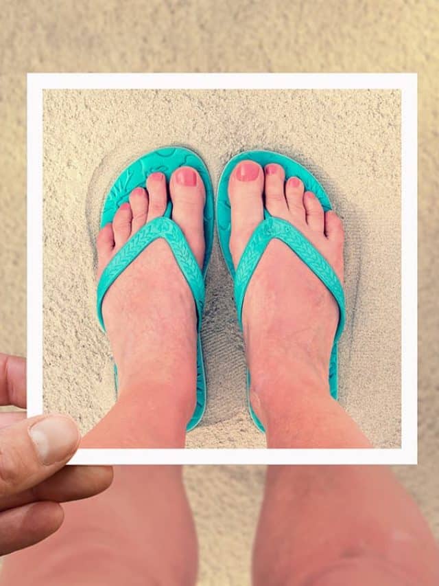 Selfie photo of woman feet wearing flip flops on a beach