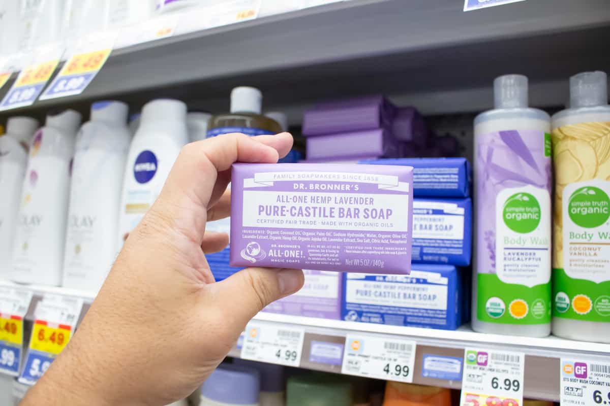 A view of a hand holding a package of Dr. Bronner's Pure-Castile bar soap