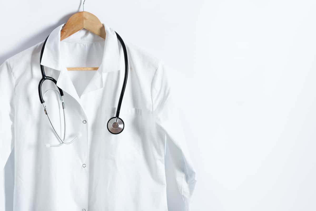 A white coat with a doctor stethoscope on a white background