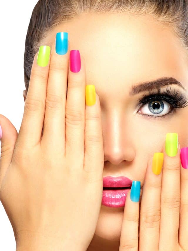 Beauty girl face with colorful nail polish. Manicure and makeup