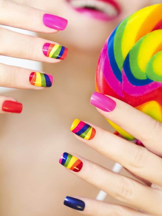 Rainbow manicure on artificial nails square shape with a Lollipop in his hand