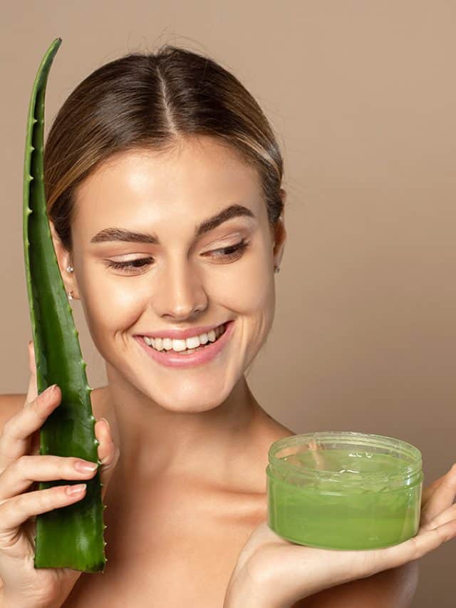cropped-Smiling-female-model-holding-aloe-leaf-and-jar-of-aloe-gel.jpg