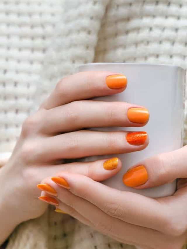 Female,Hands,With,Orange,Nail,Design,Holding,White,Cup.