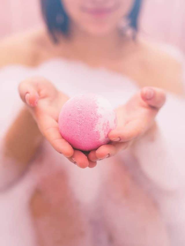 Woman,Taking,Bubbling,Ball,For,Bath.,Toned.,Pink.