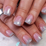 French manicure featuring pink nail beds and silver glitter tips