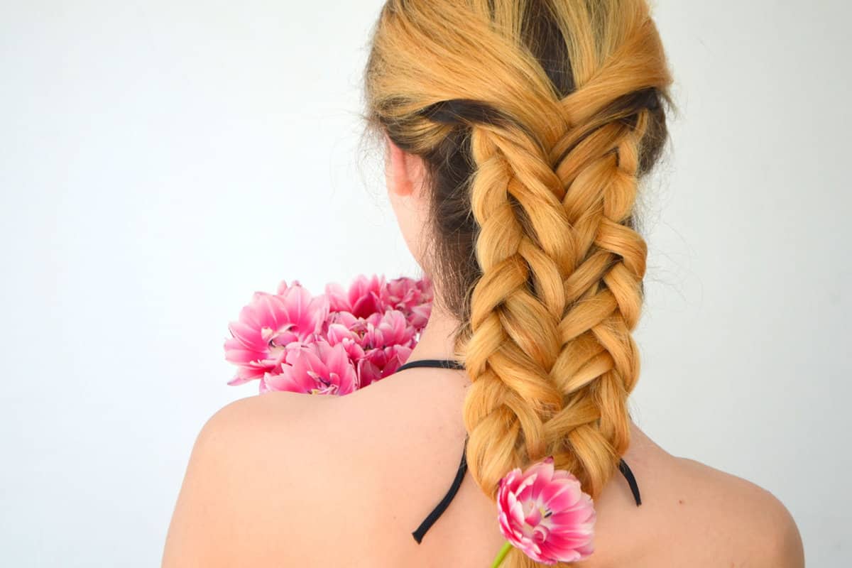 Blonde woman showing her Four Strand Braid