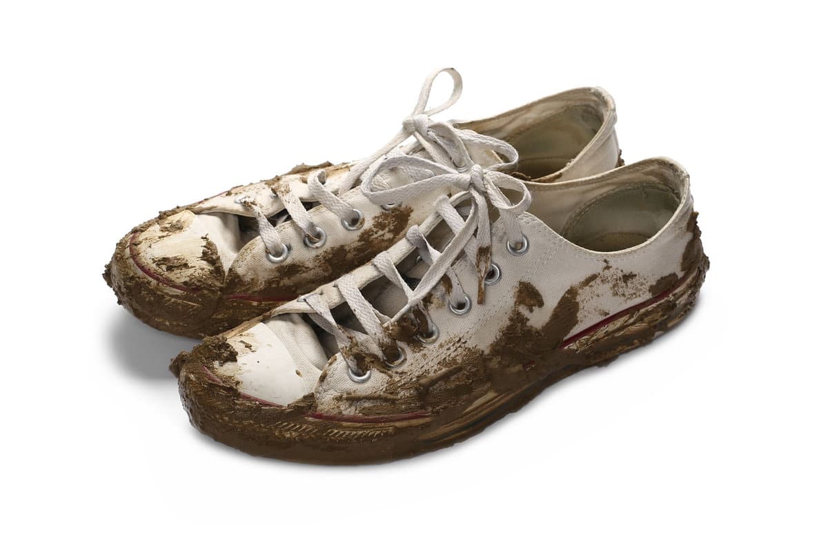 Dirty white shoes covered with mud