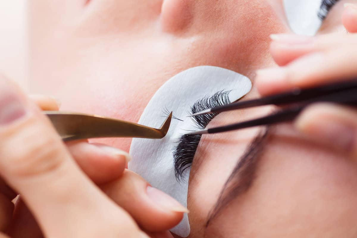 Applying lashes to client at the salon