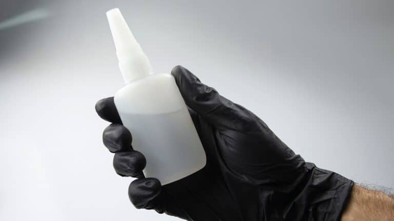 Scientist holding Cyanoacrylate glue, Is There An Eyelash Glue Without Cyanoacrylate? [A Guide to Finding Safe Alternatives] - 1600x900