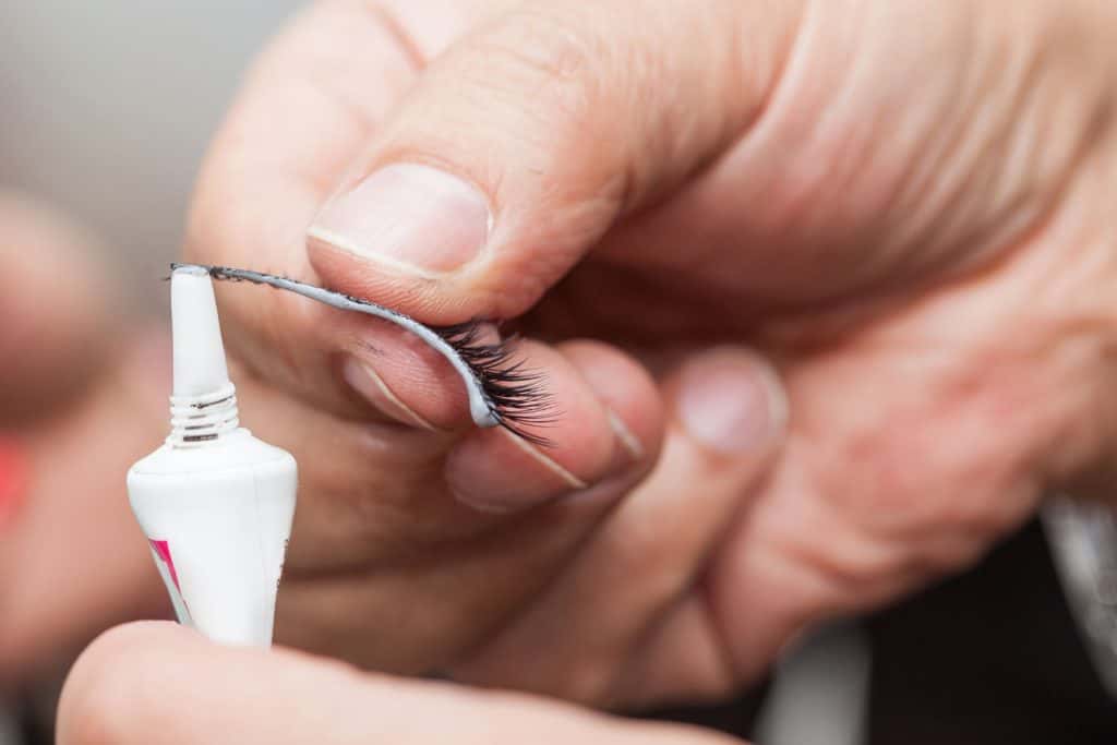 Stylist applying lash glue