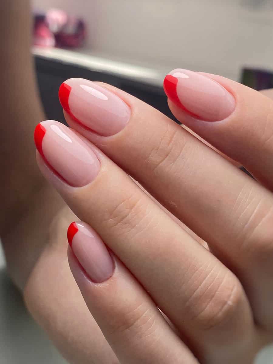 translucent nails with vibrant red tips