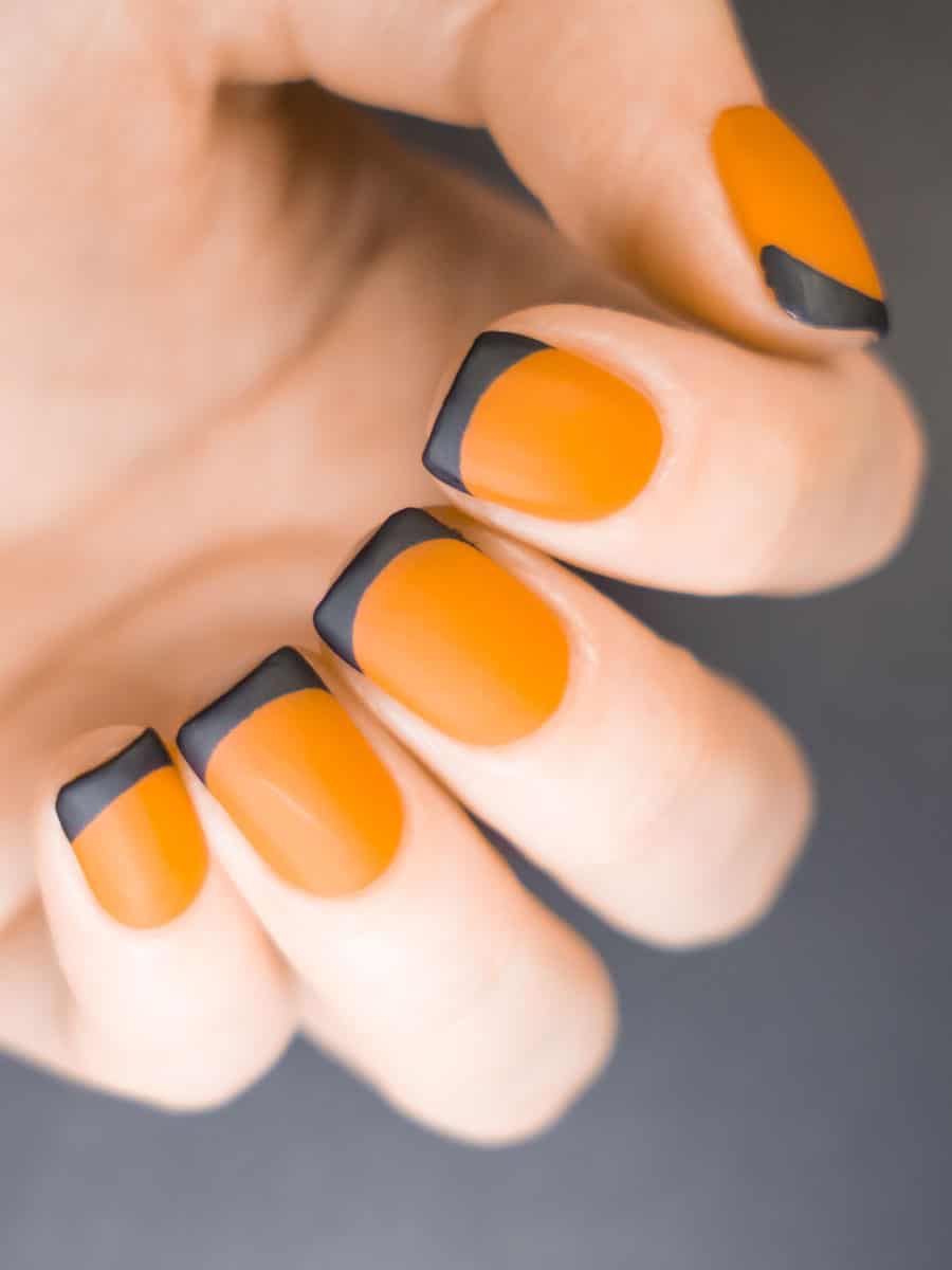orange nails with matte black French tips