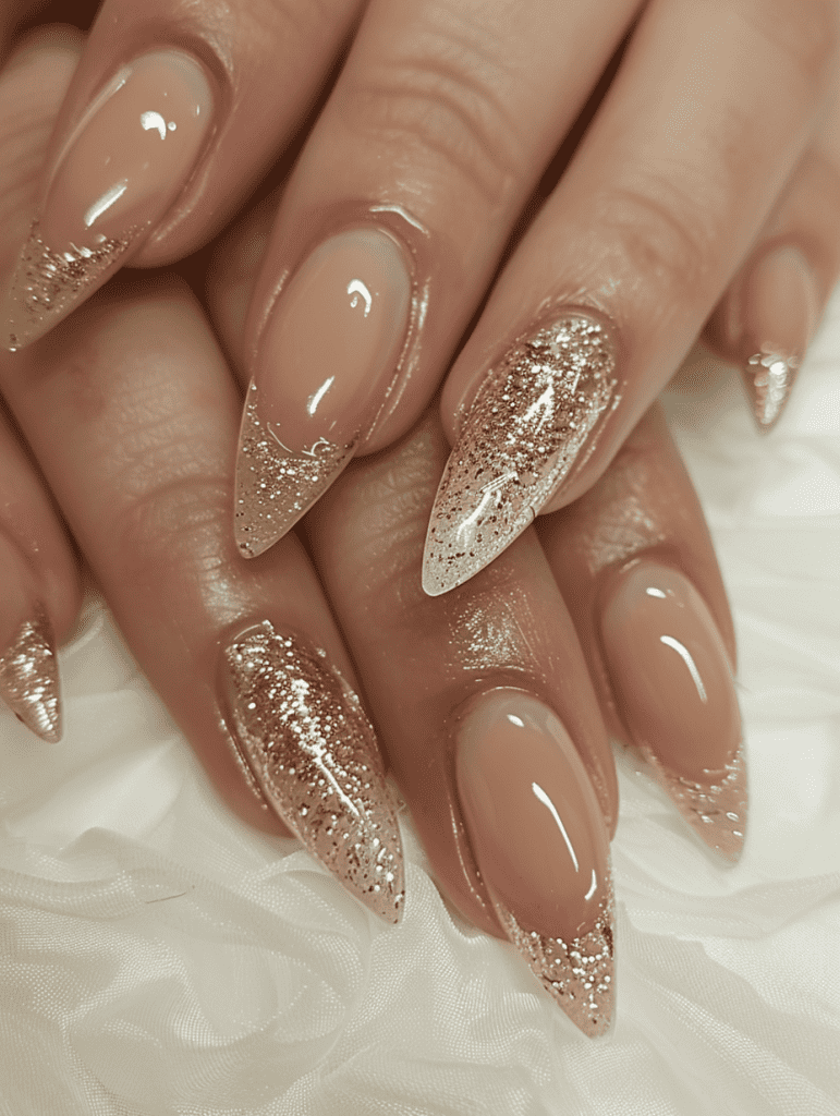 Glitter nail design with gold glitter tips on beige nails