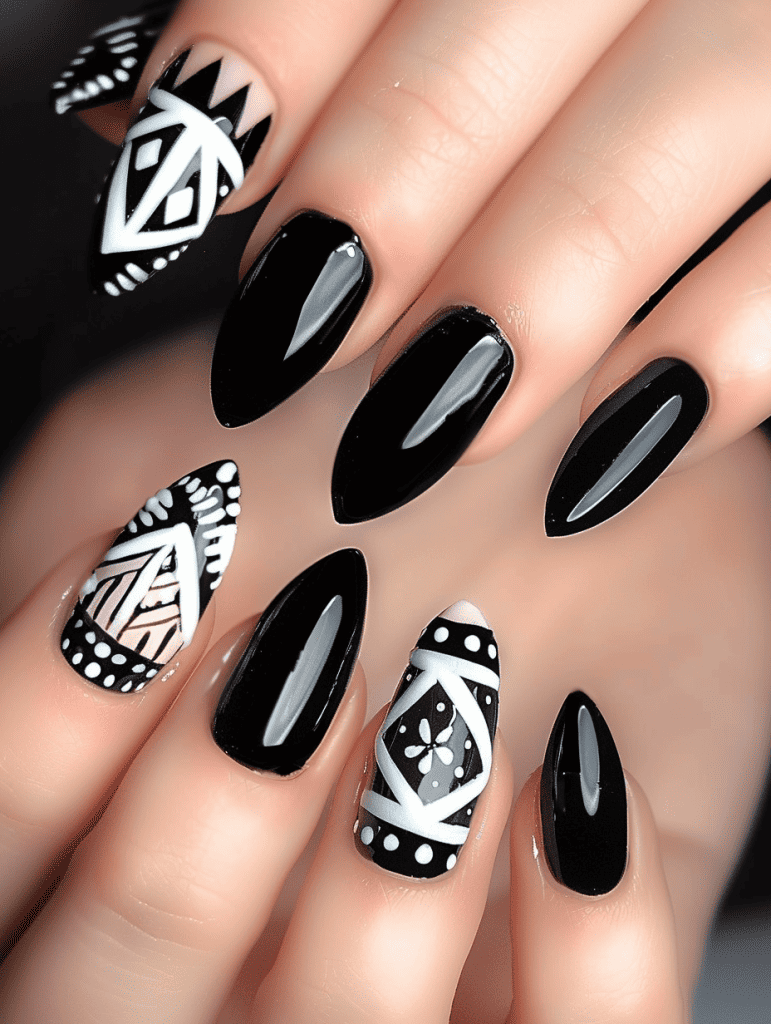 geometric nail art with black and white triangular patterns