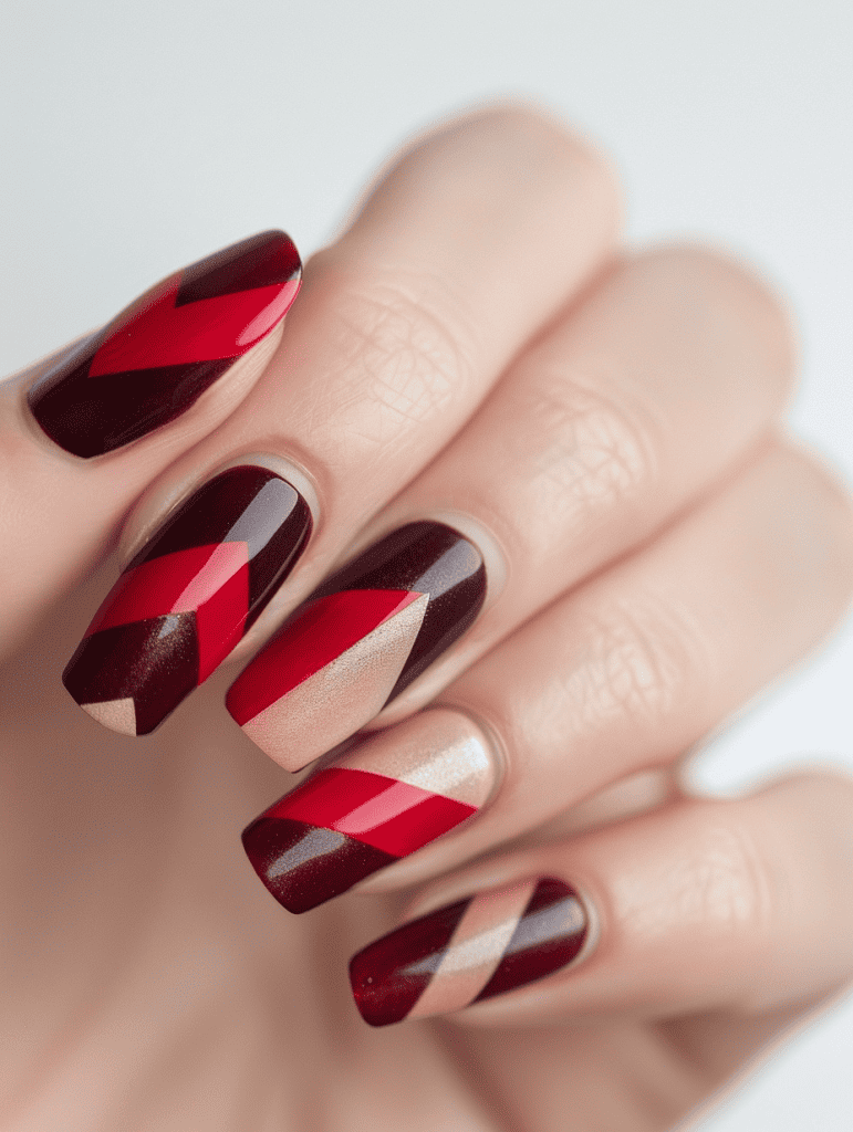geometric nail art with red and burgundy stripes