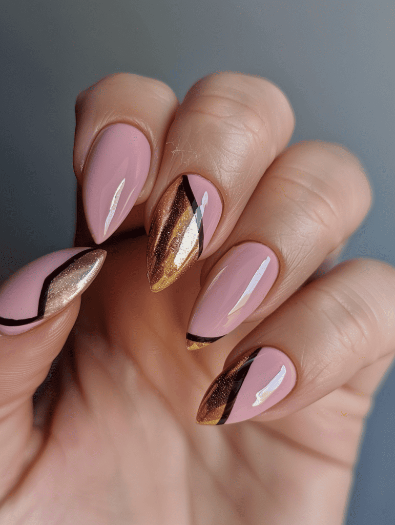 geometric nail art with metallic gold triangles on pink