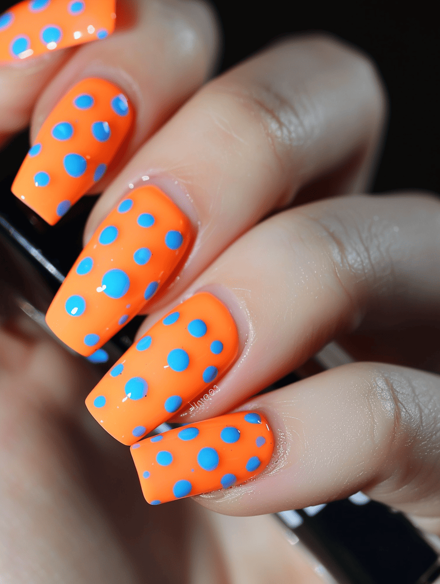 nail art. electric orange with neon blue dots
