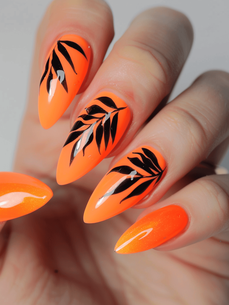 Bold and bright orange nails with black leaf accents.
