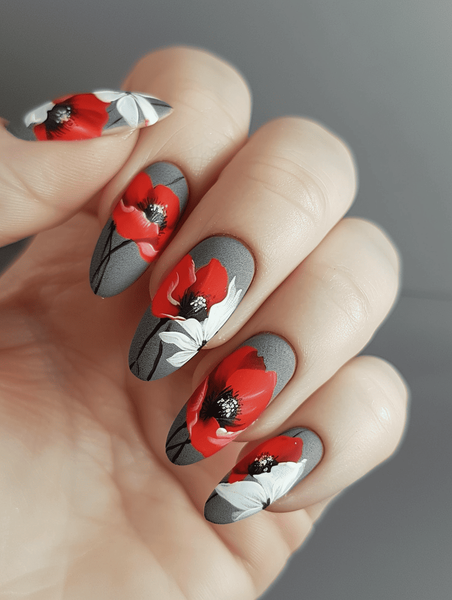 floral nail art design with red poppies on a matte grey background