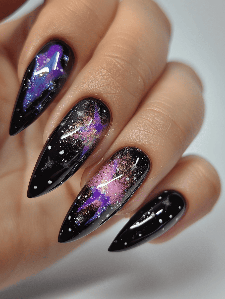 space-themed nail design. black with glowing nebula accents in purple and pink