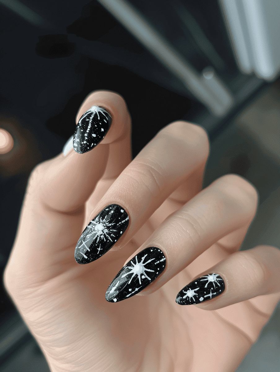 space-themed nail design. starburst patterns in white on black
