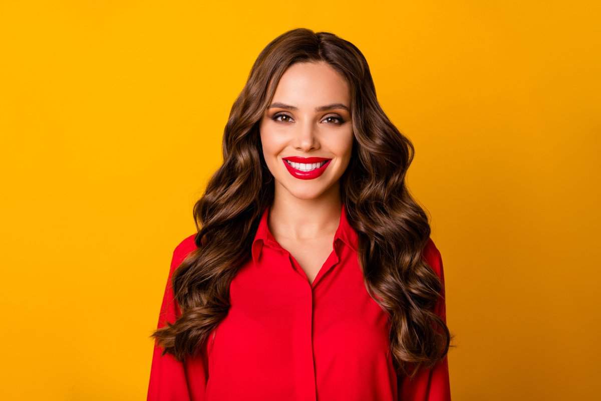 Closeup photo of pretty stunning curly business lady bright pomade bossy person friendly smiling white teeth good mood wear office red shirt isolated yellow vivid color background
