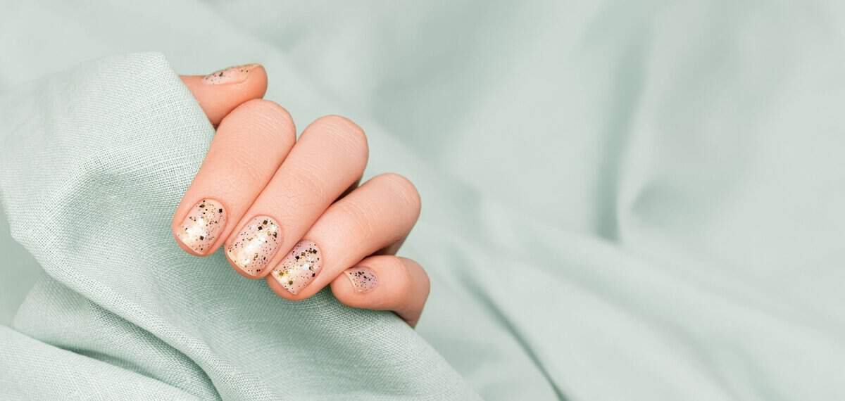 Female hand with glitter on nails manicure