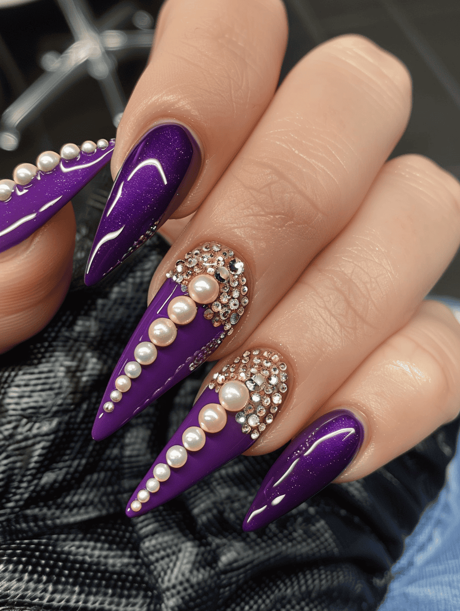Purple pointed nails with pearl  and crystal embellishments
