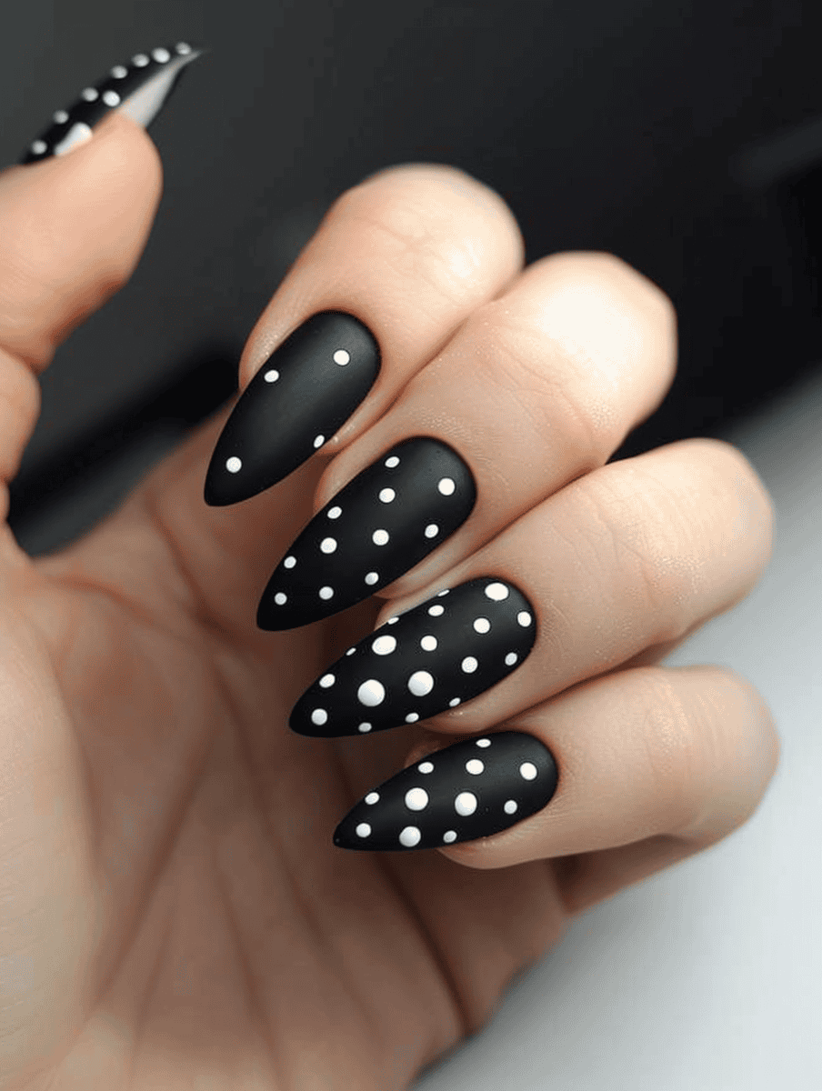 matte black nail design with white polka dots