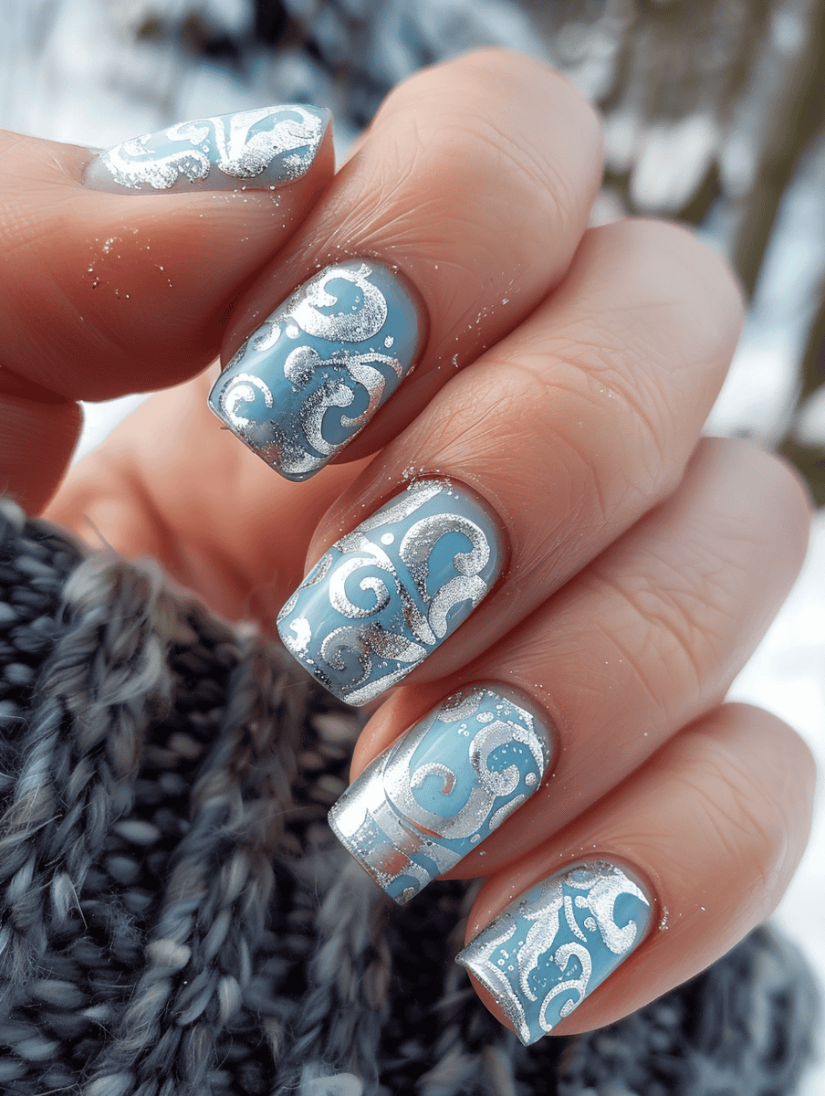Pale blue with silver swirls winter nail design