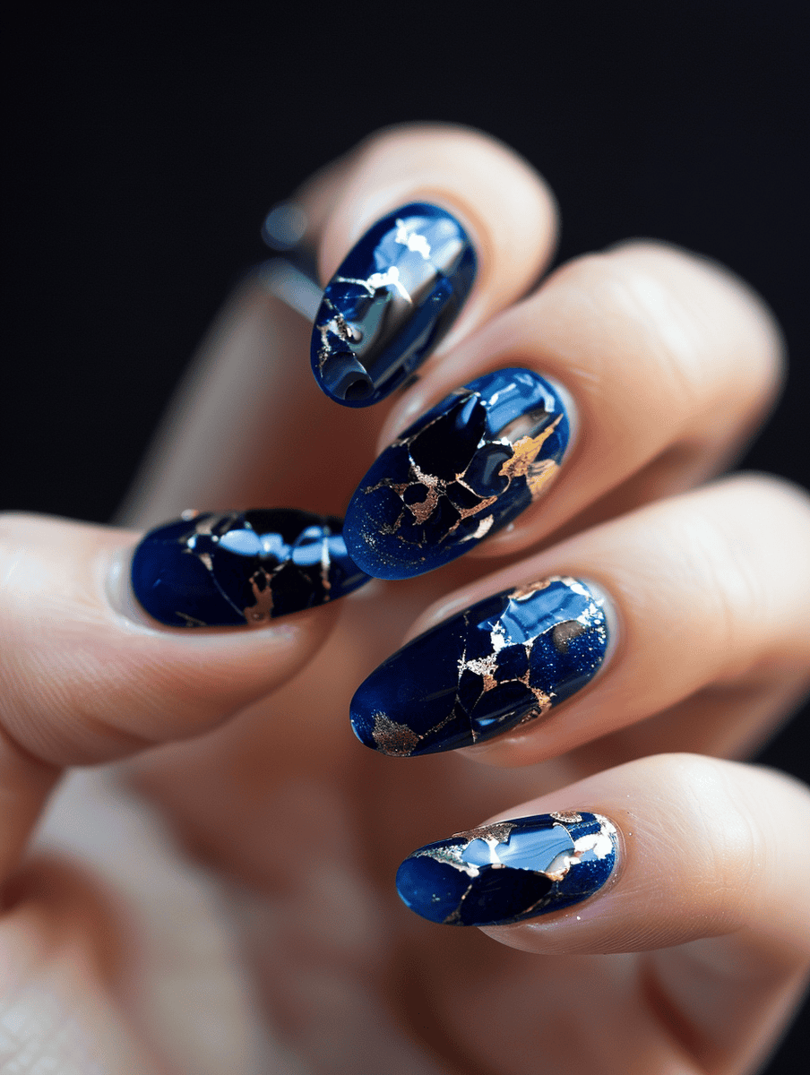 Shattered deep blue glass nail design with gold glass highlights