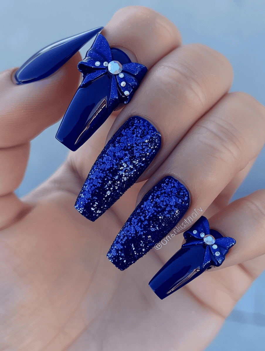 prom nail inspo. deep blue with glittery blue bows