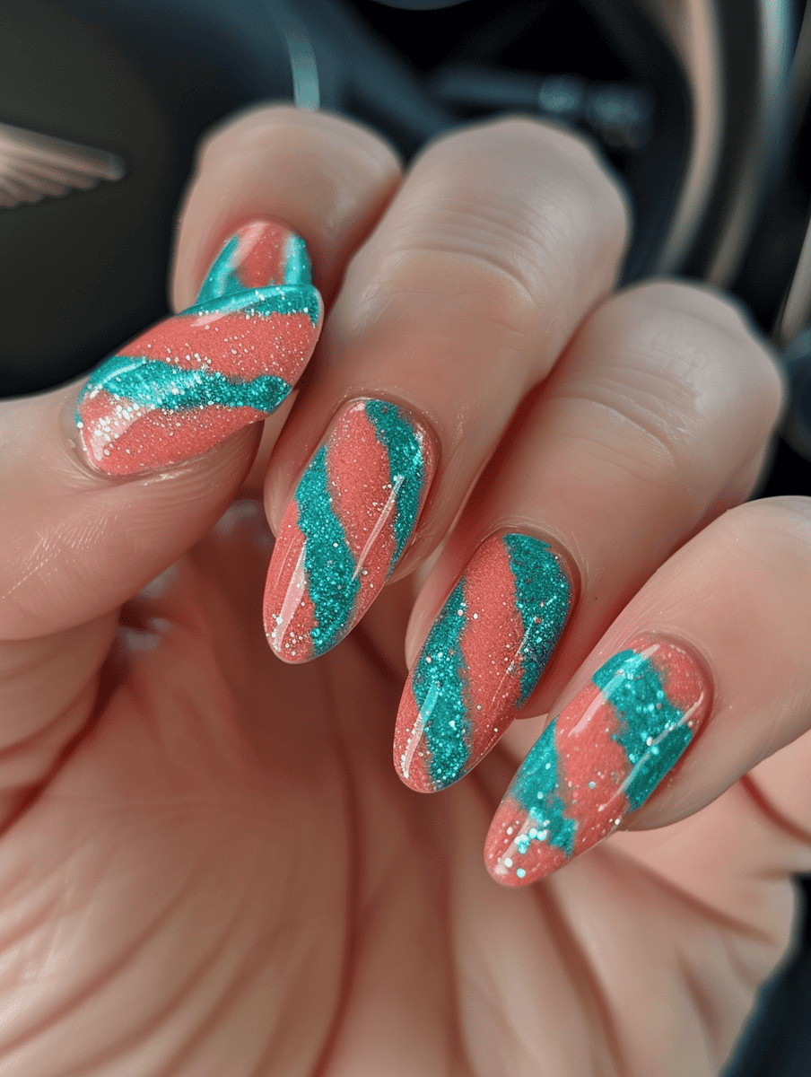 Teal and coral striped nail design with clear glitter overlay