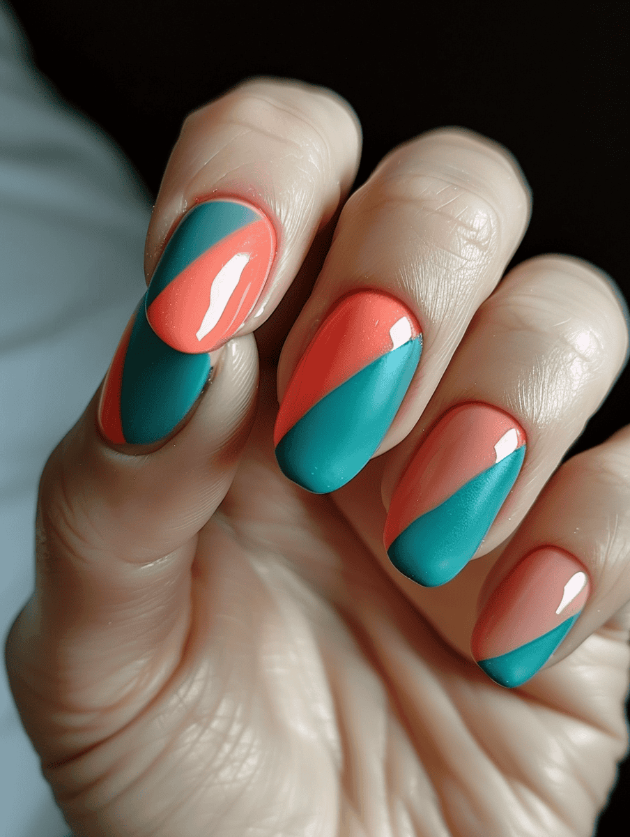 Teal and coral nail design with a diagonal split pattern